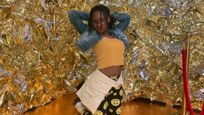 A 3/4 view of someone wearing a pair of off-white pockets in a gold foil covered background